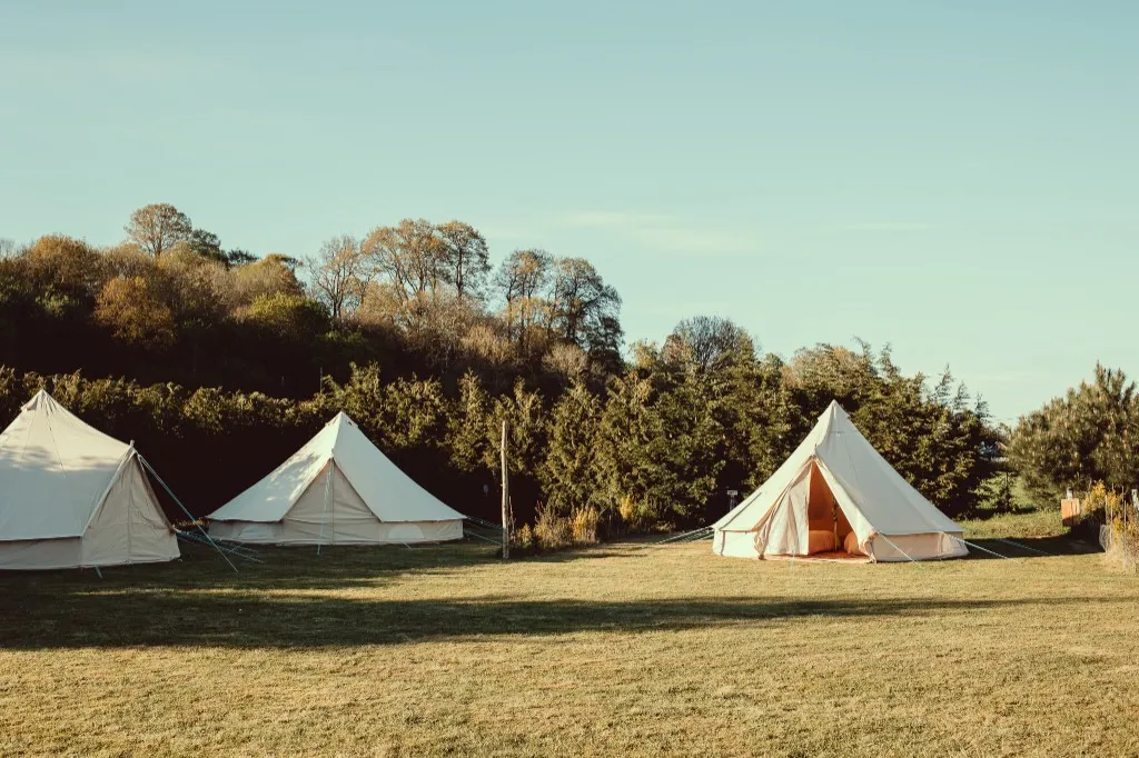 Bell tents for overnight guests in the grounds at Woodhill Weddings, Faversham, Kent