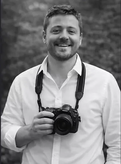 Ben Hodges holding a camera outdoors, wedding videographer for Ben Hodges Films