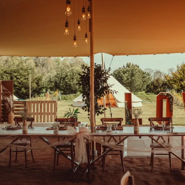 A wedding reception under the Bedouin stretch tent at Woodhill Weddings, Faversham, Kent