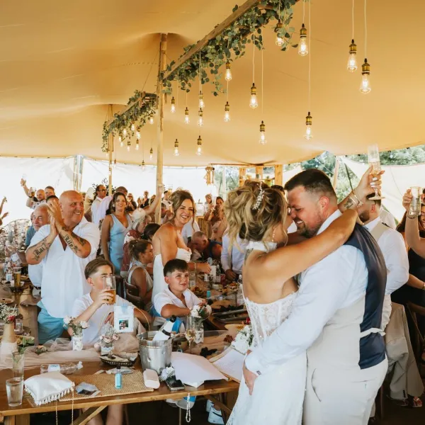 Newlyweds celebrating their first dance under the stretch tent at Woodhill Weddings, Faversham, Kent